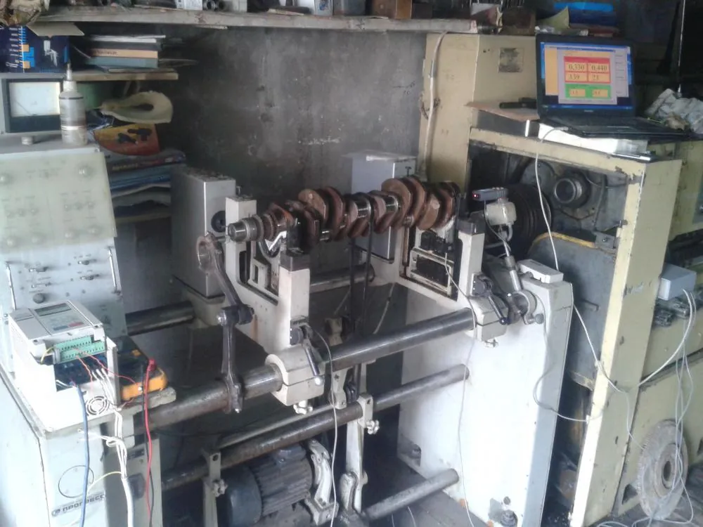 Close-up of the integration of Balanset-1A OEM into the control system of an old balancing stand.